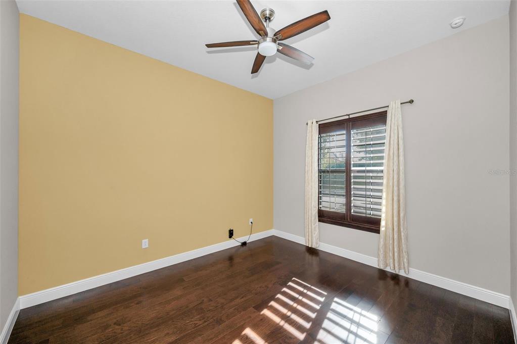 9829 Milano Drive Trinity, FL 34655 - Photo 65 of 100 an empty room with wooden floor and windows