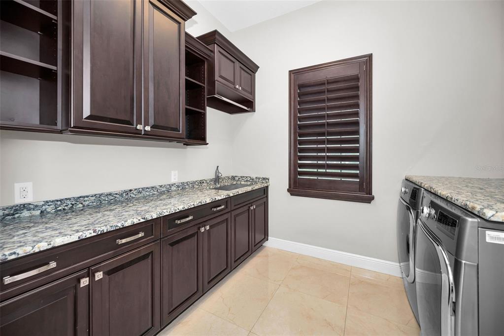 9829 Milano Drive Trinity, FL 34655 - Photo 68 of 100 a kitchen with granite countertop stainless steel appliances a stove sink and cabinets
