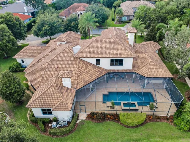 an aerial view of a house with outdoor space and lake view