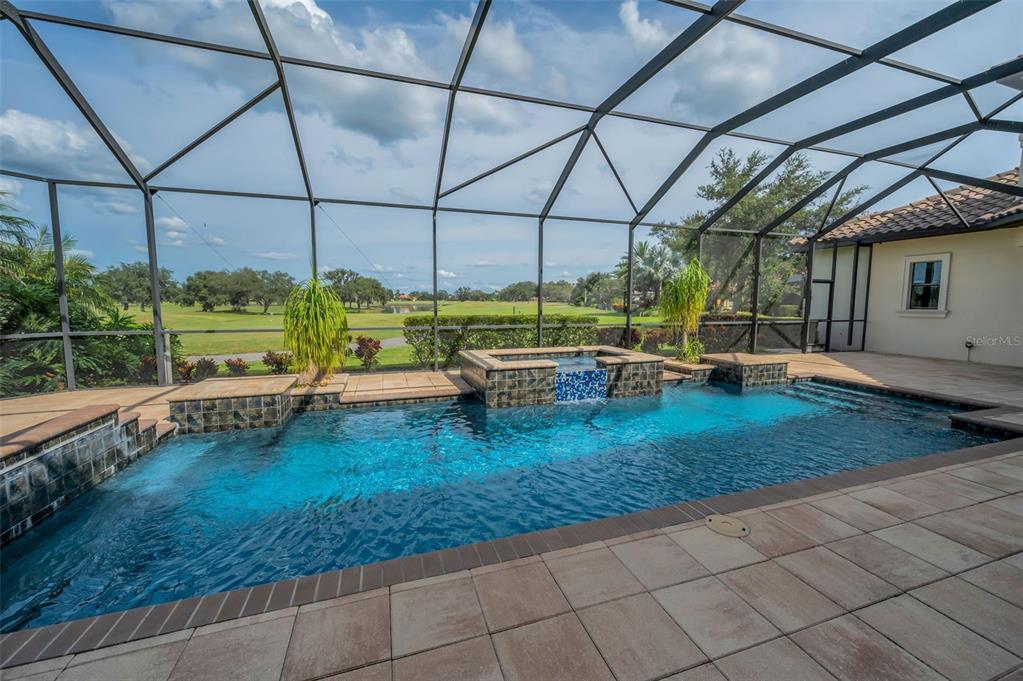 9829 Milano Drive Trinity, FL 34655 - Photo 90 of 100 a backyard of a house with barbeque oven table and chairs