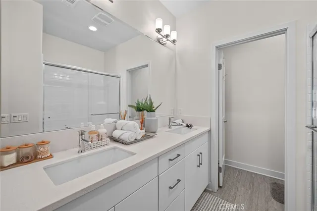 a bathroom with a sink vanity granite and a mirror
