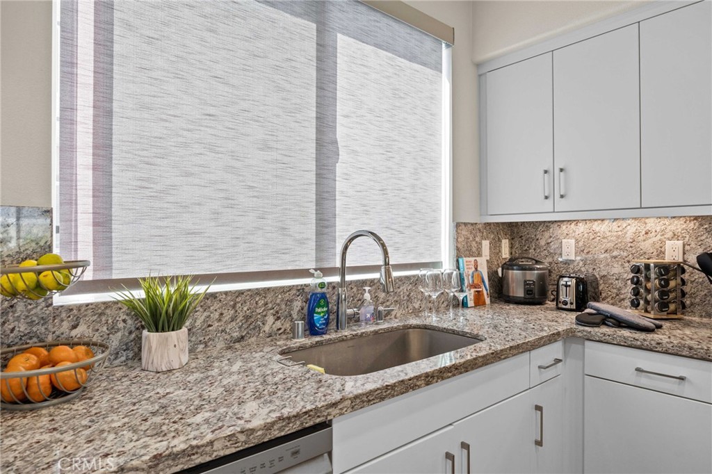 9040 Garvey Avenue, Unit 5 Rosemead, CA 91770 - Photo 17 of 33 a kitchen with granite countertop a sink a granite counter tops and a white cabinets