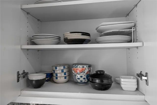 a kitchen with a microwave and shelf