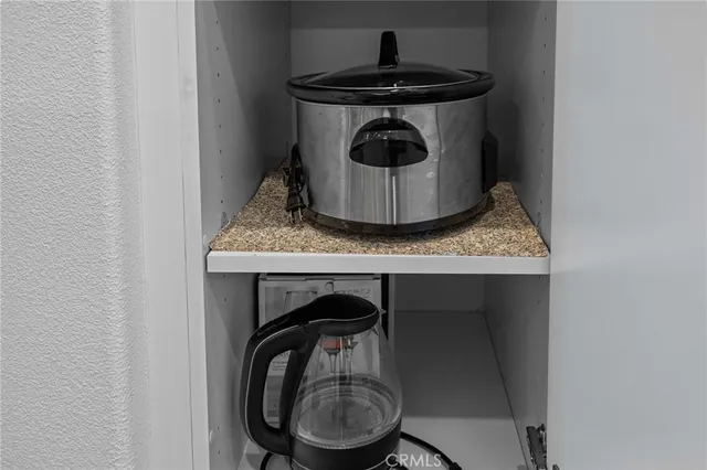 a kitchen with a stove and a wooden floor