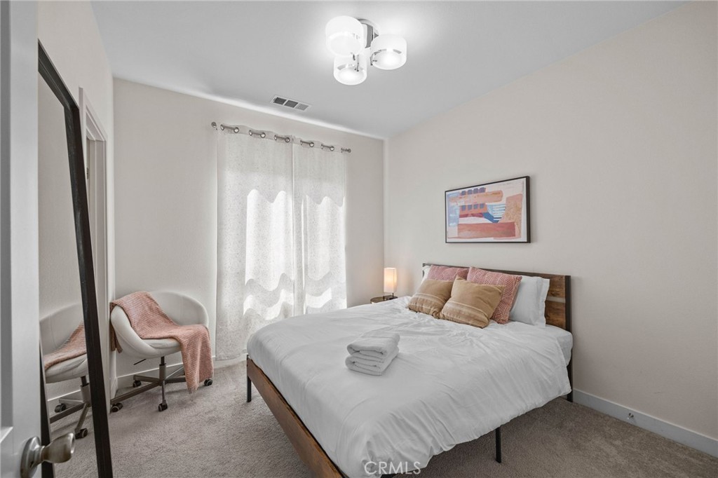 9040 Garvey Avenue, Unit 5 Rosemead, CA 91770 - Photo 29 of 33 a bedroom with a bed and a mirror