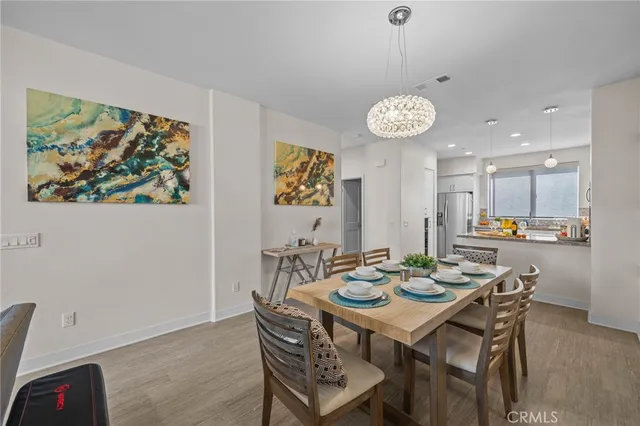 a view of a dining room with furniture and chandelier