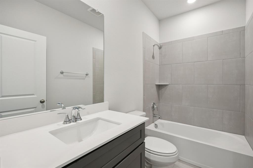 529 Magellan Road Seagoville, TX 75159 - Photo 14 of 37 a bathroom with a sink a toilet and shower