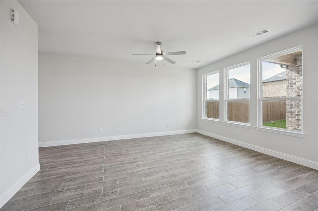 529 Magellan Road Seagoville, TX 75159 - Photo 8 of 37 wooden floor in an empty room with a window