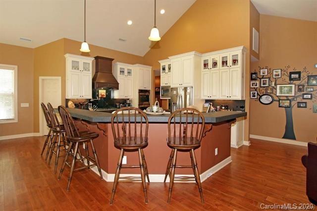 165 Regency Road Salisbury, NC 28147 - Photo 14 of 47 a kitchen with stainless steel appliances kitchen island granite countertop a table chairs and a refrigerator