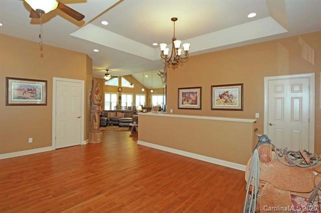 165 Regency Road Salisbury, NC 28147 - Photo 7 of 47 a view of a livingroom with furniture chandelier fan and wooden floor