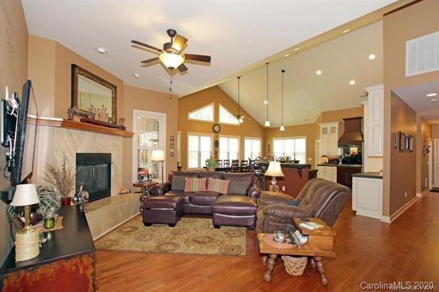 165 Regency Road Salisbury, NC 28147 - Photo 9 of 47 a living room with furniture a fireplace and a chandelier