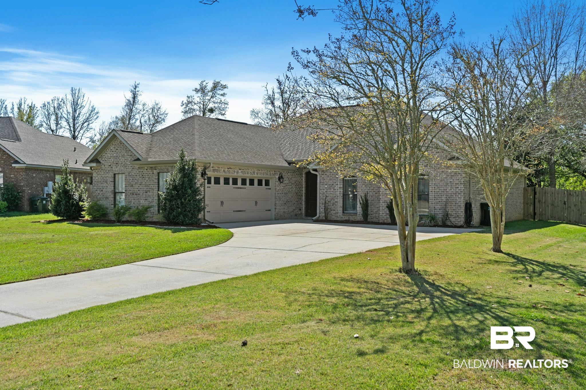 9584 Sanibel Loop Daphne, AL 36526 - Photo 3 of 48 View of front facade featuring brick siding, a garage, a shingled roof, and concrete driveway