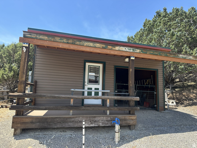 2006 Swenson Valley Road Bancroft, ID 83217 - Photo 41 of 51 Outbuilding with tan horizontal siding, covered porch, and dual-pane windows