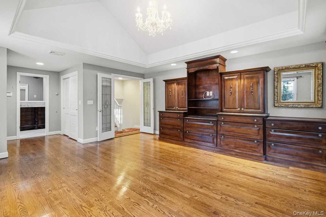 51 Bay Road Huntington Bay, NY 11743 - Photo 24 of 42 an empty room with wooden floor fireplace and windows