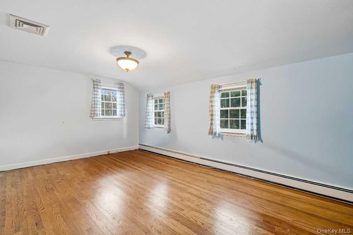 51 Bay Road Huntington Bay, NY 11743 - Photo 26 of 42 a view of an empty room with wooden floor and a window