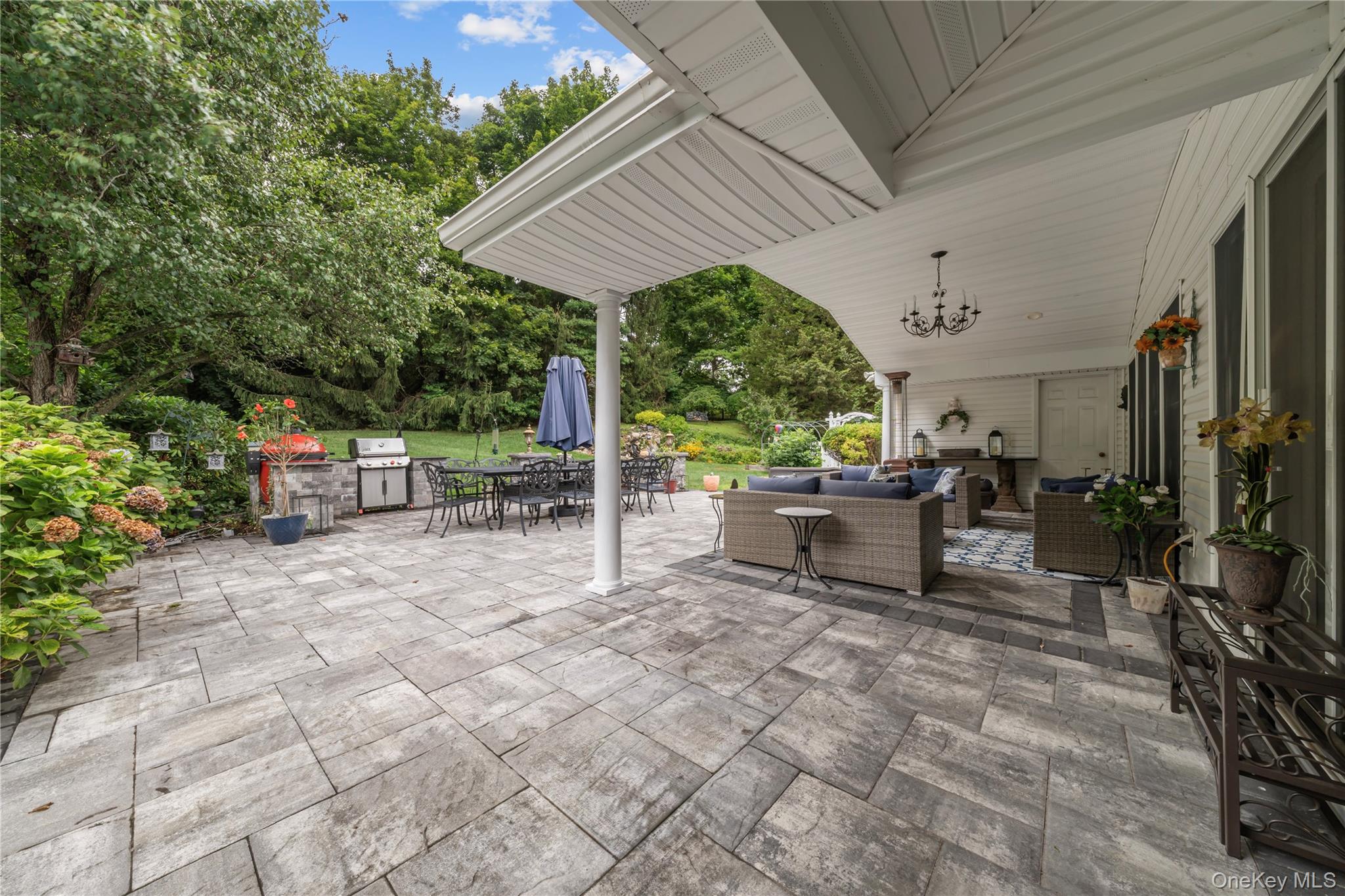51 Bay Road Huntington Bay, NY 11743 - Photo 31 of 42 a view of a patio with table and chairs potted plants with a barbeque grill and plants