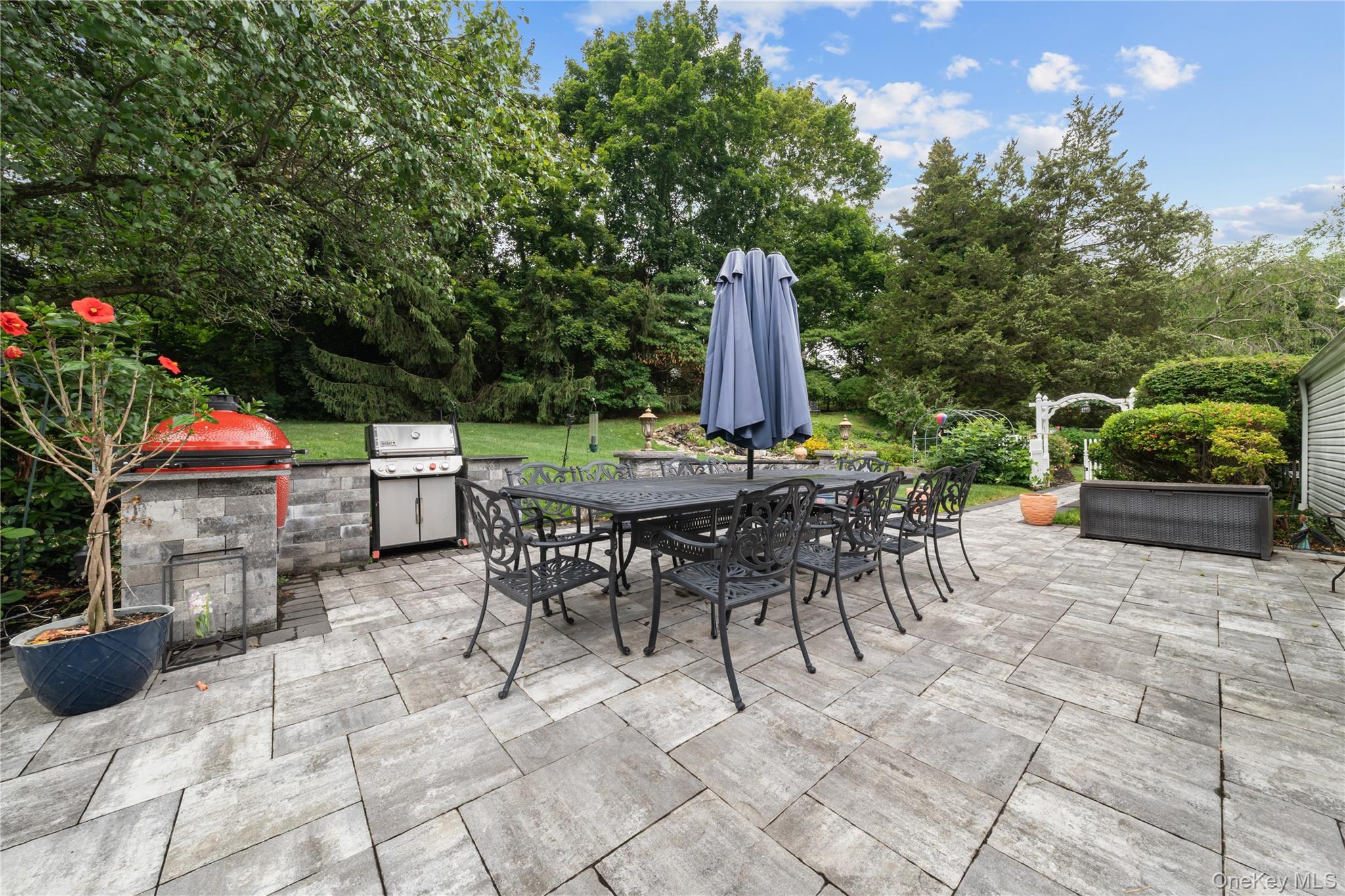 51 Bay Road Huntington Bay, NY 11743 - Photo 32 of 42 View of patio with outdoor dining area, view of scattered trees, and exterior kitchen