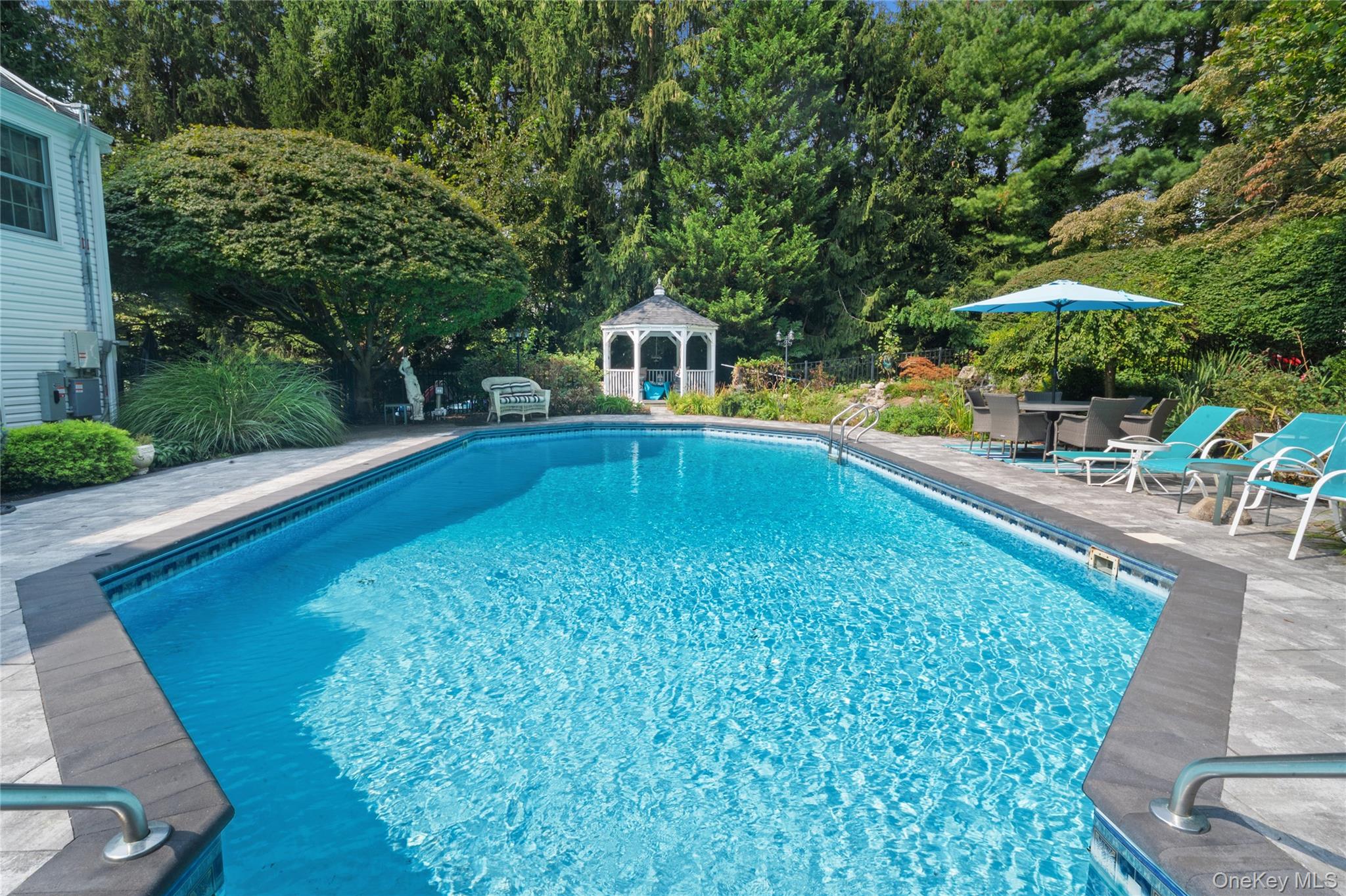 51 Bay Road Huntington Bay, NY 11743 - Photo 33 of 42 a view of a swimming pool with a patio