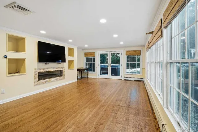 a view of a livingroom with furniture flat screen tv and staircase