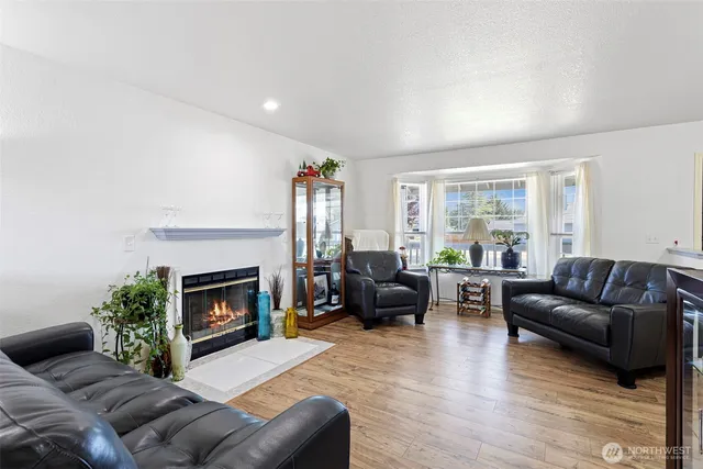 a living room with furniture window and a fireplace