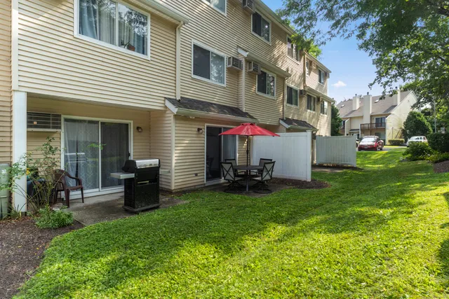 a view of a house with backyard and sitting area