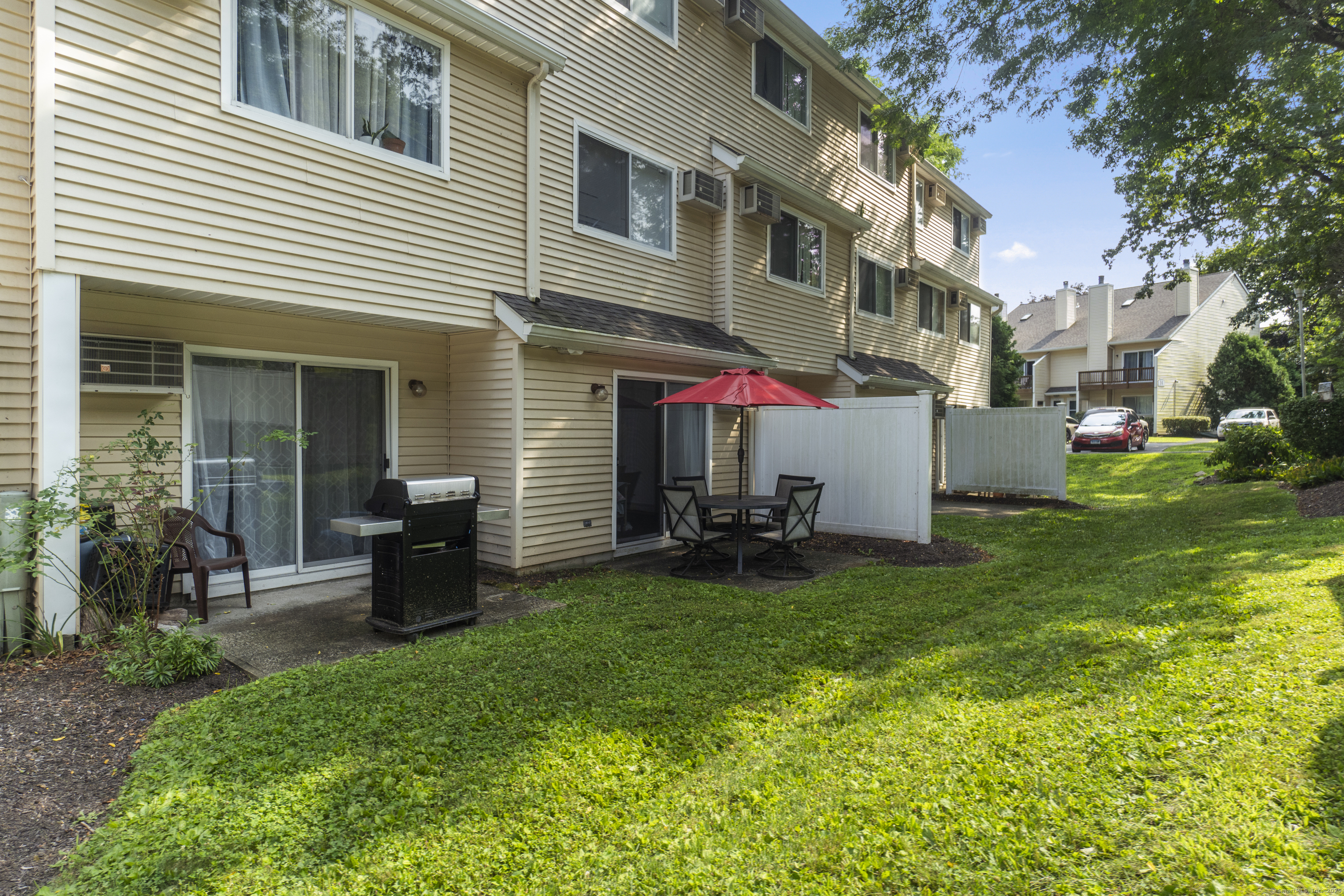 8 Rose Lane, Unit 105 Danbury, CT 06811 - Photo 15 of 20 a view of a house with backyard and sitting area