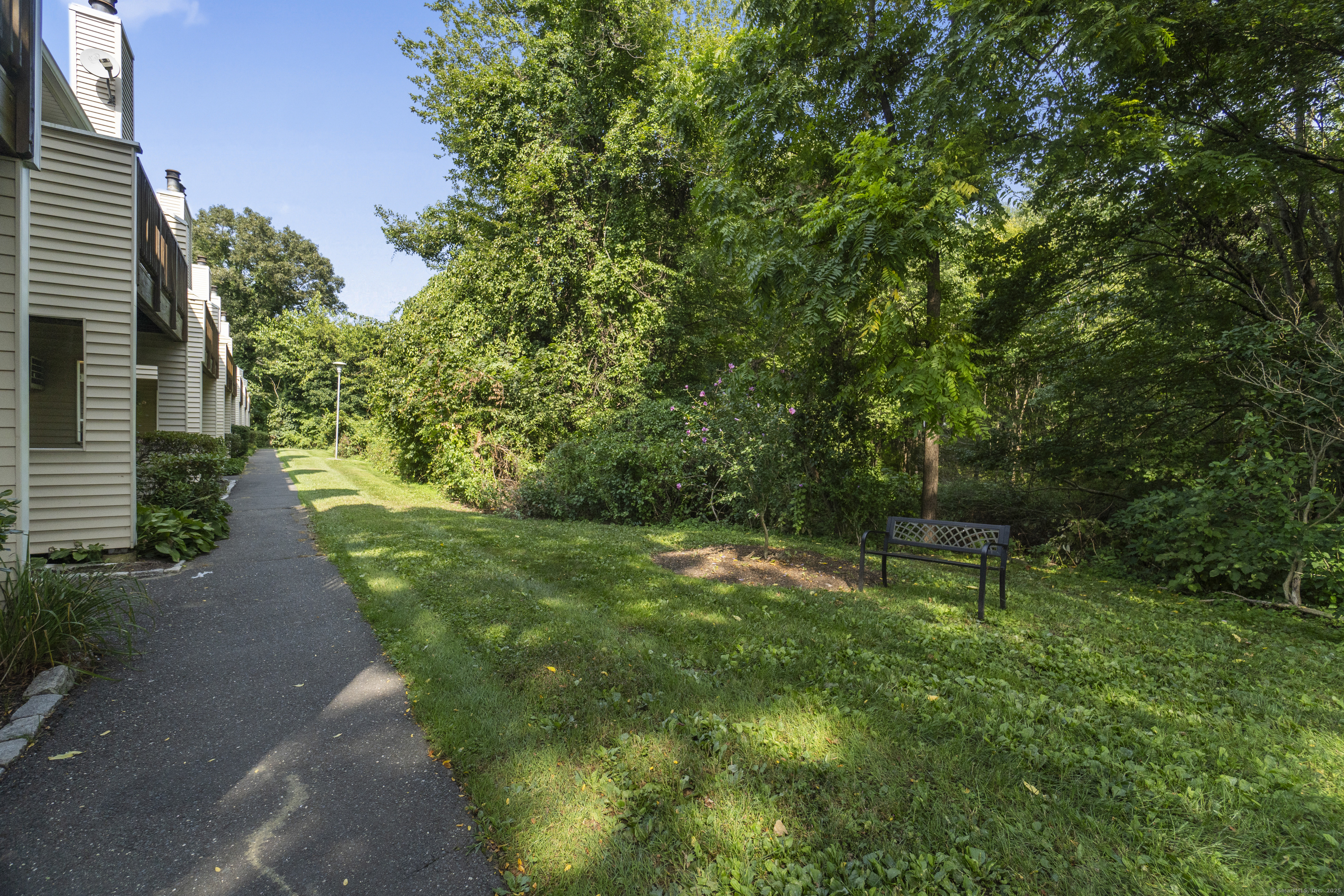 8 Rose Lane, Unit 105 Danbury, CT 06811 - Photo 17 of 20 a view of a backyard with a garden