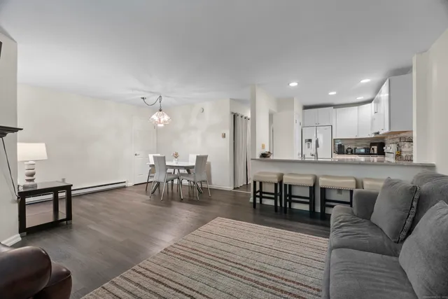a living room with furniture and kitchen view