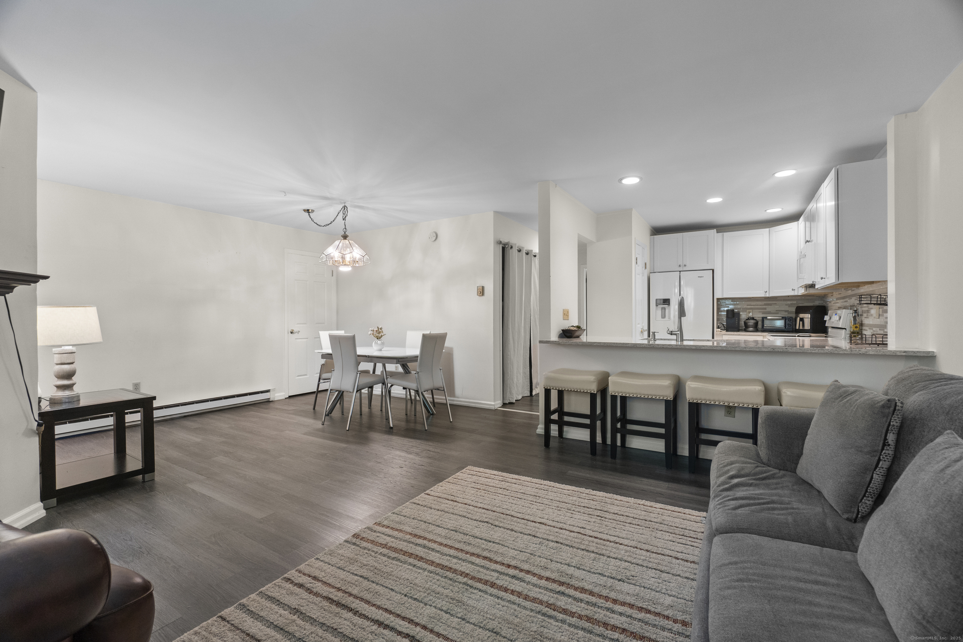 8 Rose Lane, Unit 105 Danbury, CT 06811 - Photo 2 of 20 a living room with furniture and kitchen view