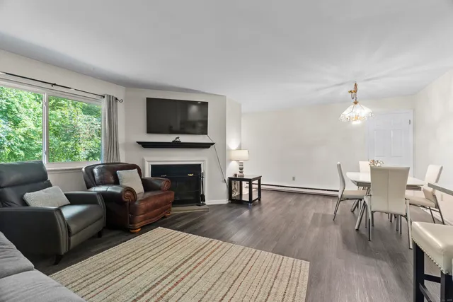 a living room with furniture fireplace and a flat screen tv