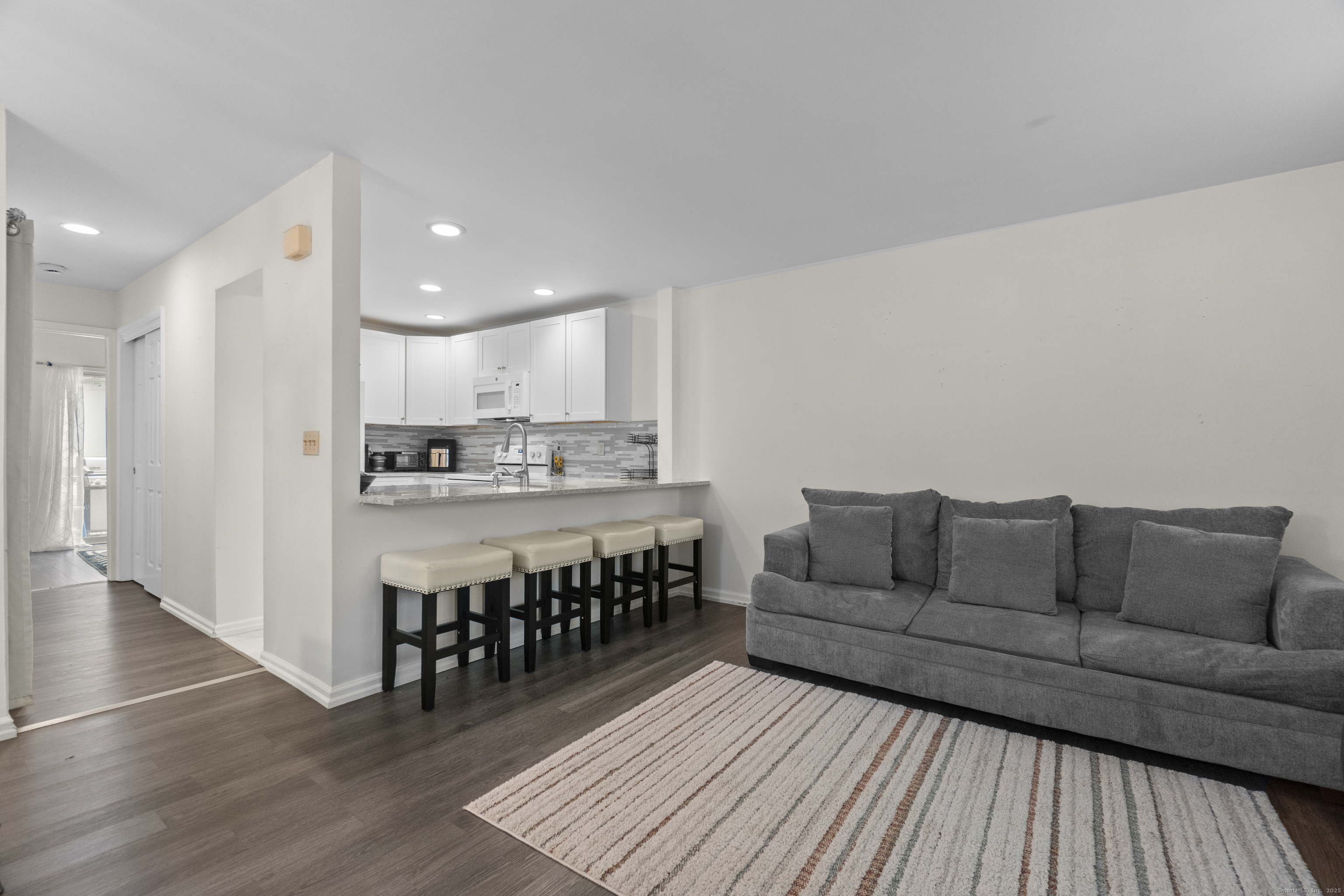 8 Rose Lane, Unit 105 Danbury, CT 06811 - Photo 5 of 20 a living room with furniture and a wooden floor