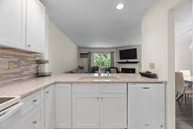 a kitchen with cabinets appliances and a sink