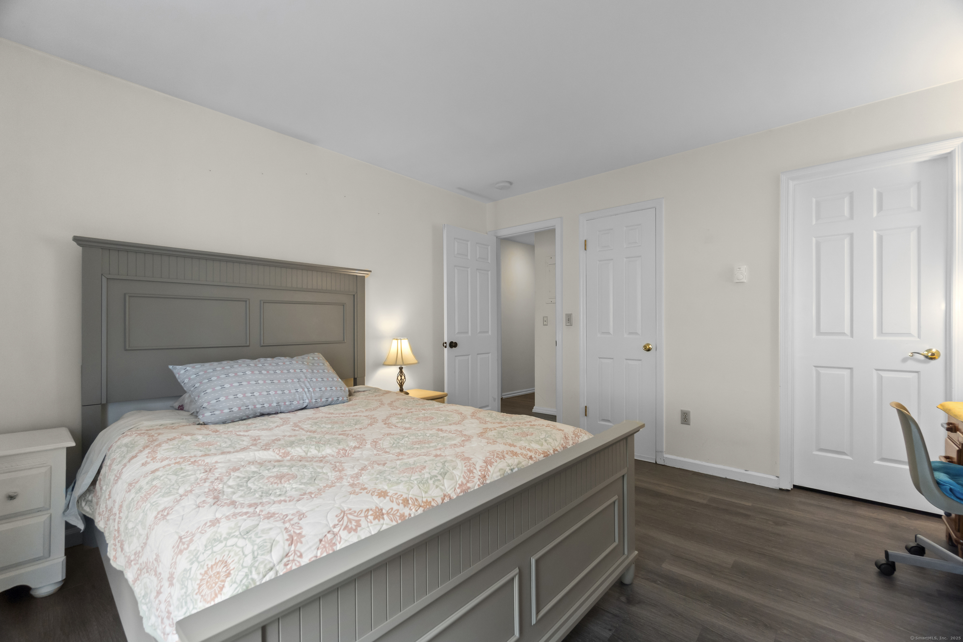 8 Rose Lane, Unit 105 Danbury, CT 06811 - Photo 10 of 20 a bedroom with a bed and wooden floor