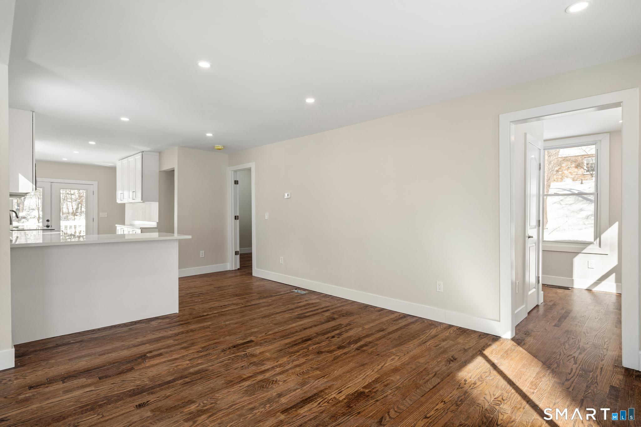 6 Juniper Ridge Drive Danbury, CT 06811 - Photo 8 of 36 a view of an empty room with wooden floor and a window