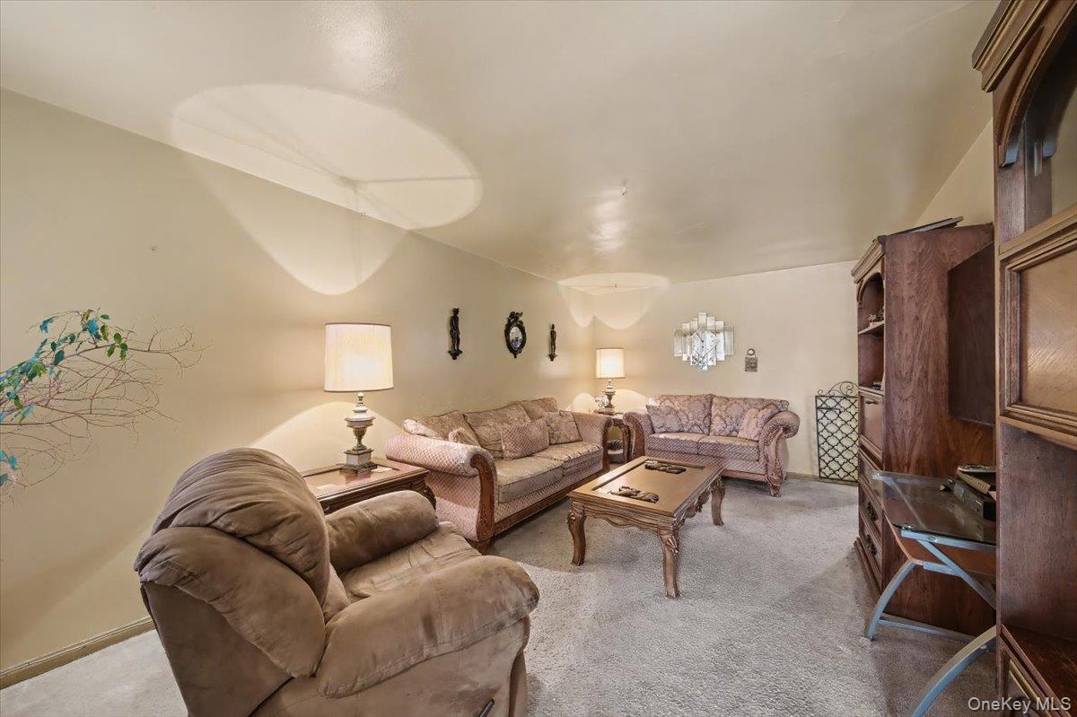 2715 Dewitt Place Bronx, NY 10469 - Photo 2 of 12 a living room with furniture a couch and a flat screen tv