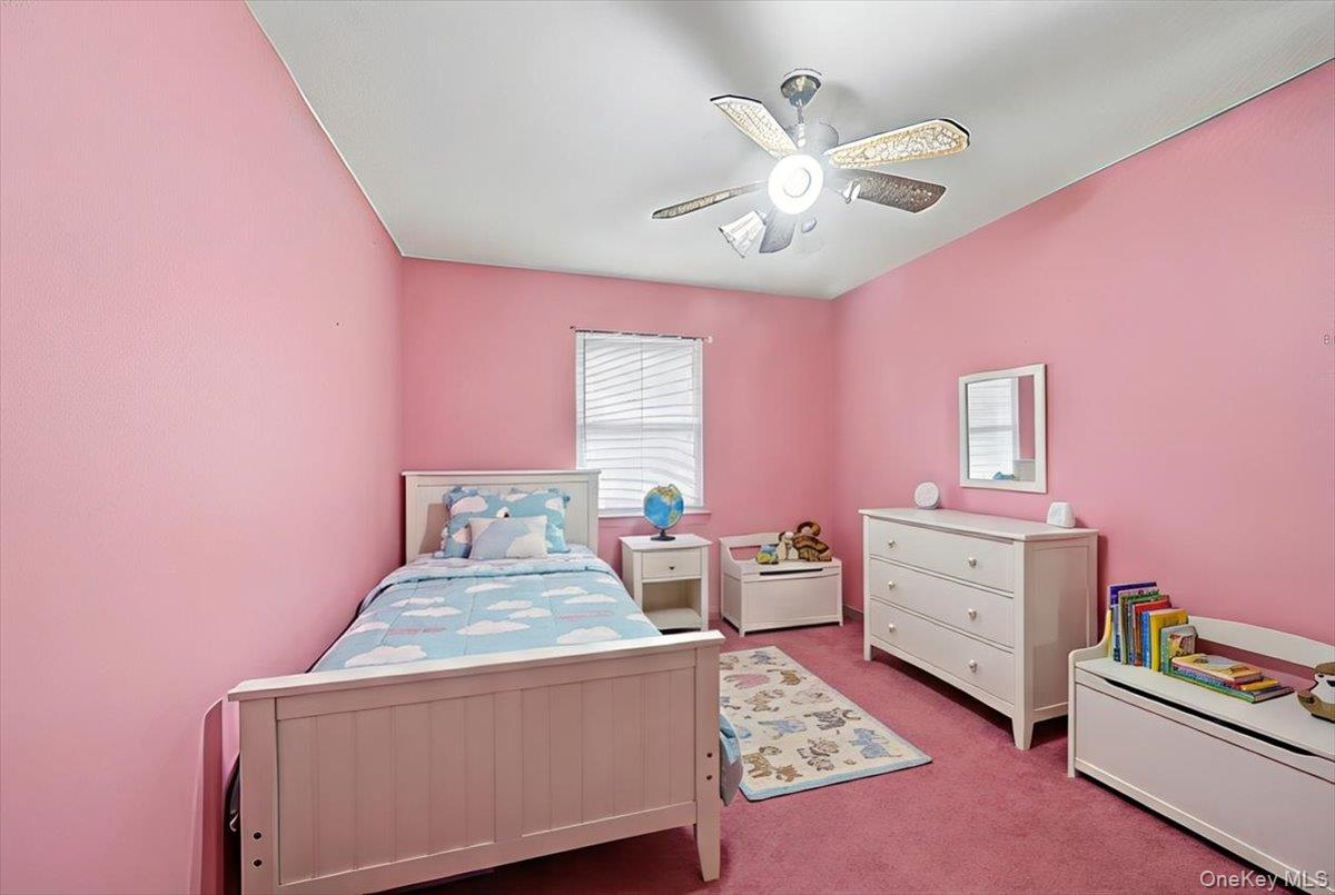 2715 Dewitt Place Bronx, NY 10469 - Photo 6 of 12 a bed room with a bed and a dresser