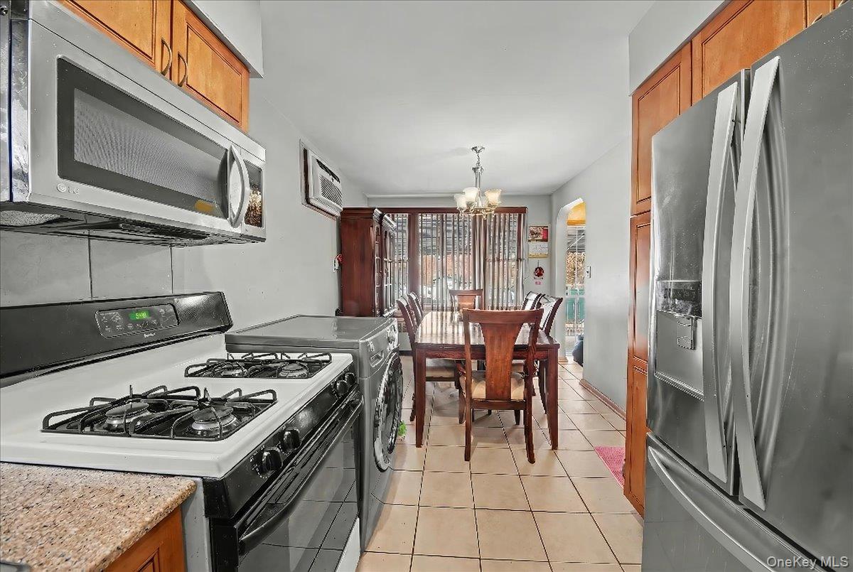 2715 Dewitt Place Bronx, NY 10469 - Photo 8 of 12 a kitchen with a stove and a microwave