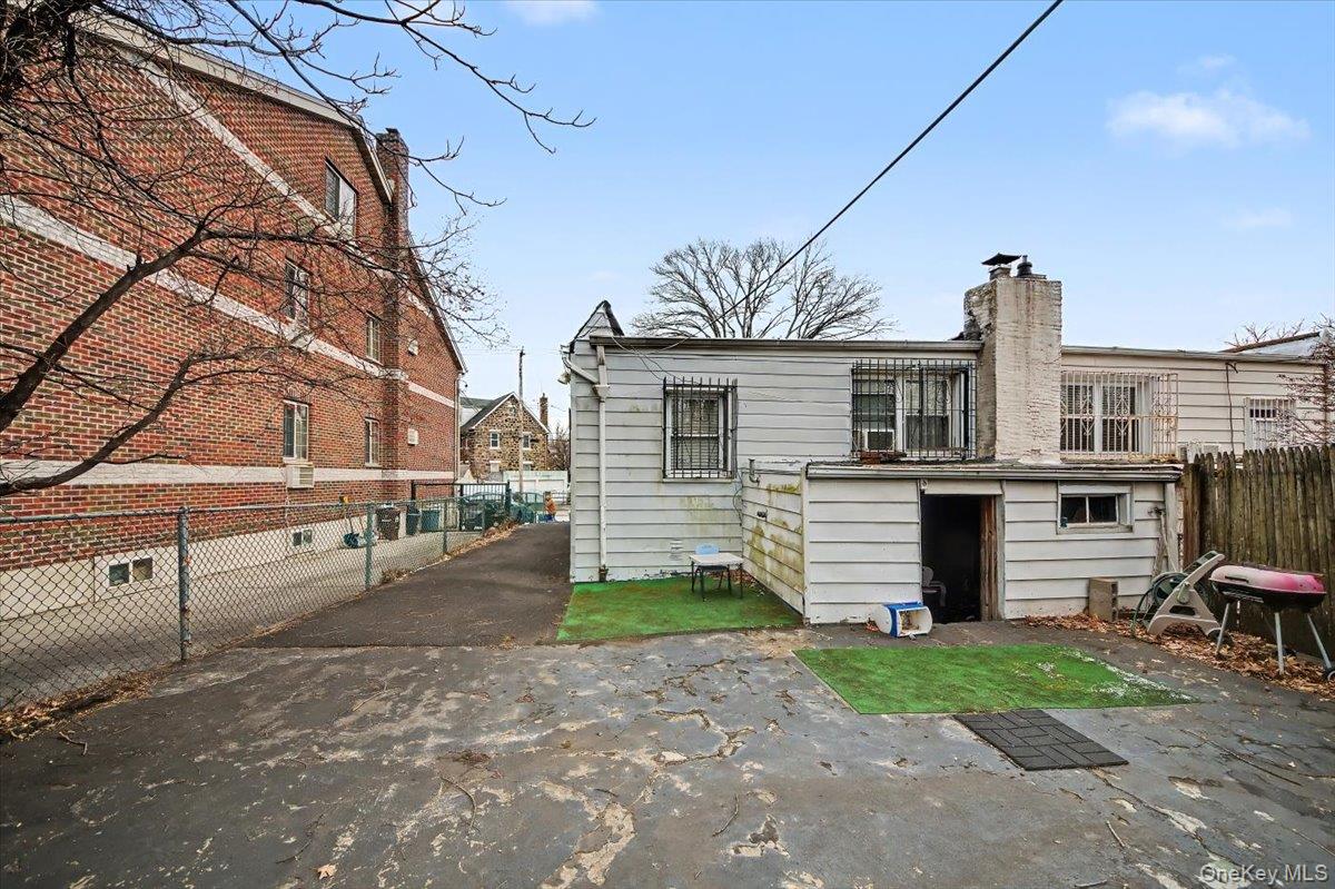 2715 Dewitt Place Bronx, NY 10469 - Photo 10 of 12 a front view of a house with a yard and garage