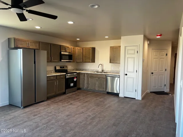 a kitchen with stainless steel appliances a refrigerator and a sink