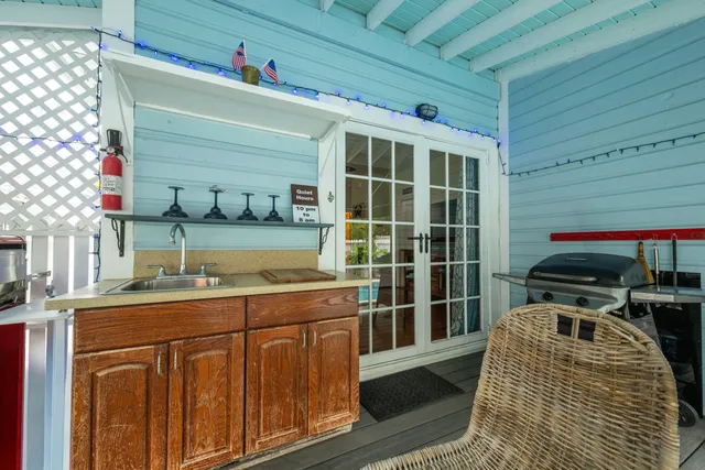 a kitchen with a sink and wooden floor