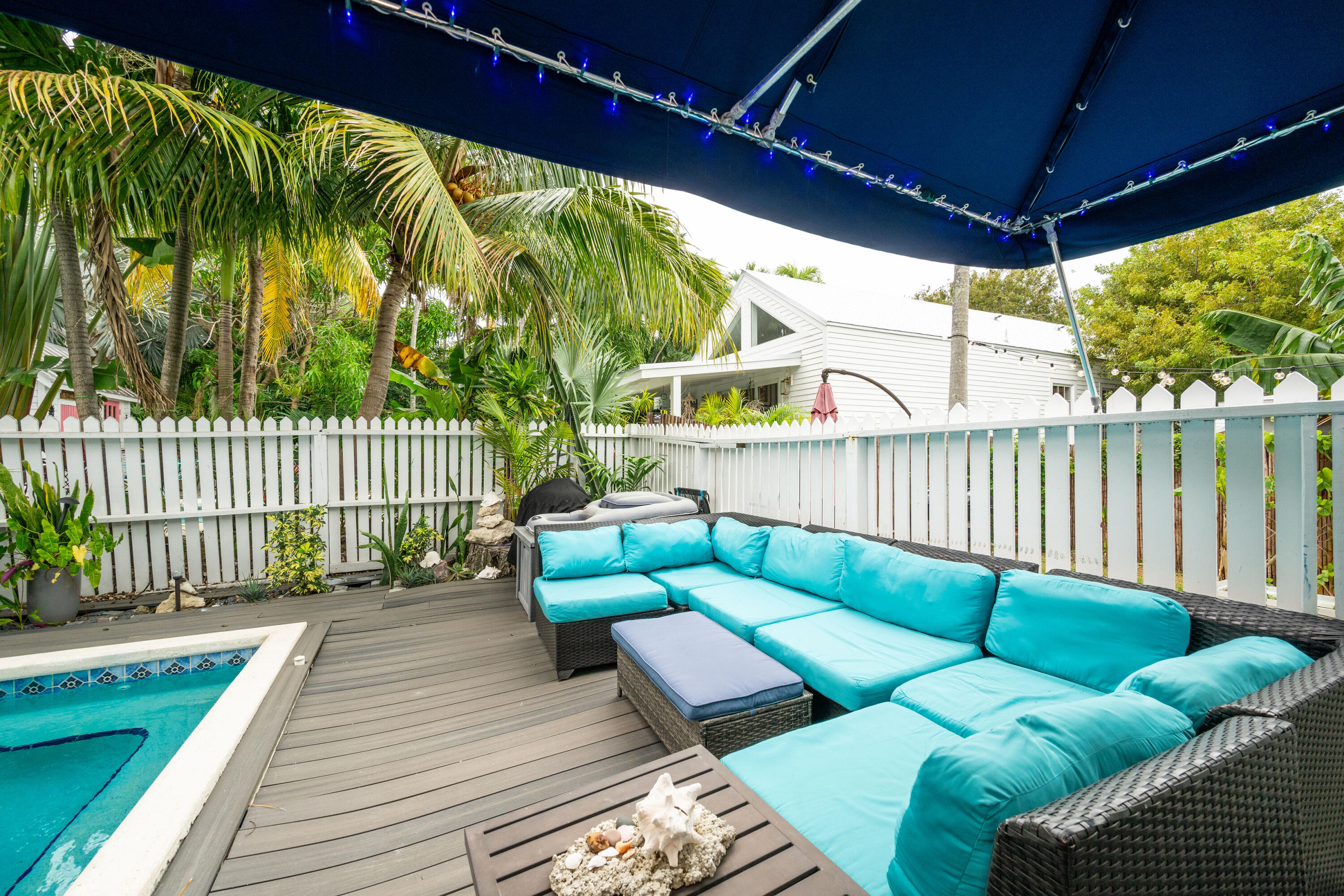 906 Truman Avenue, Unit 2 Key West, FL 33040 - Photo 16 of 33 a roof deck with couches and wooden floor