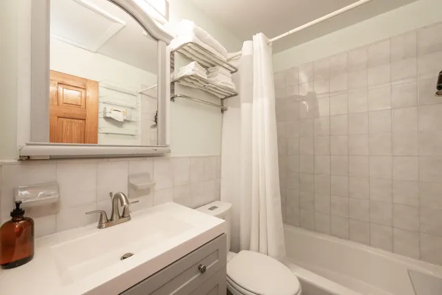 a bedroom with a bed and a ceiling fan