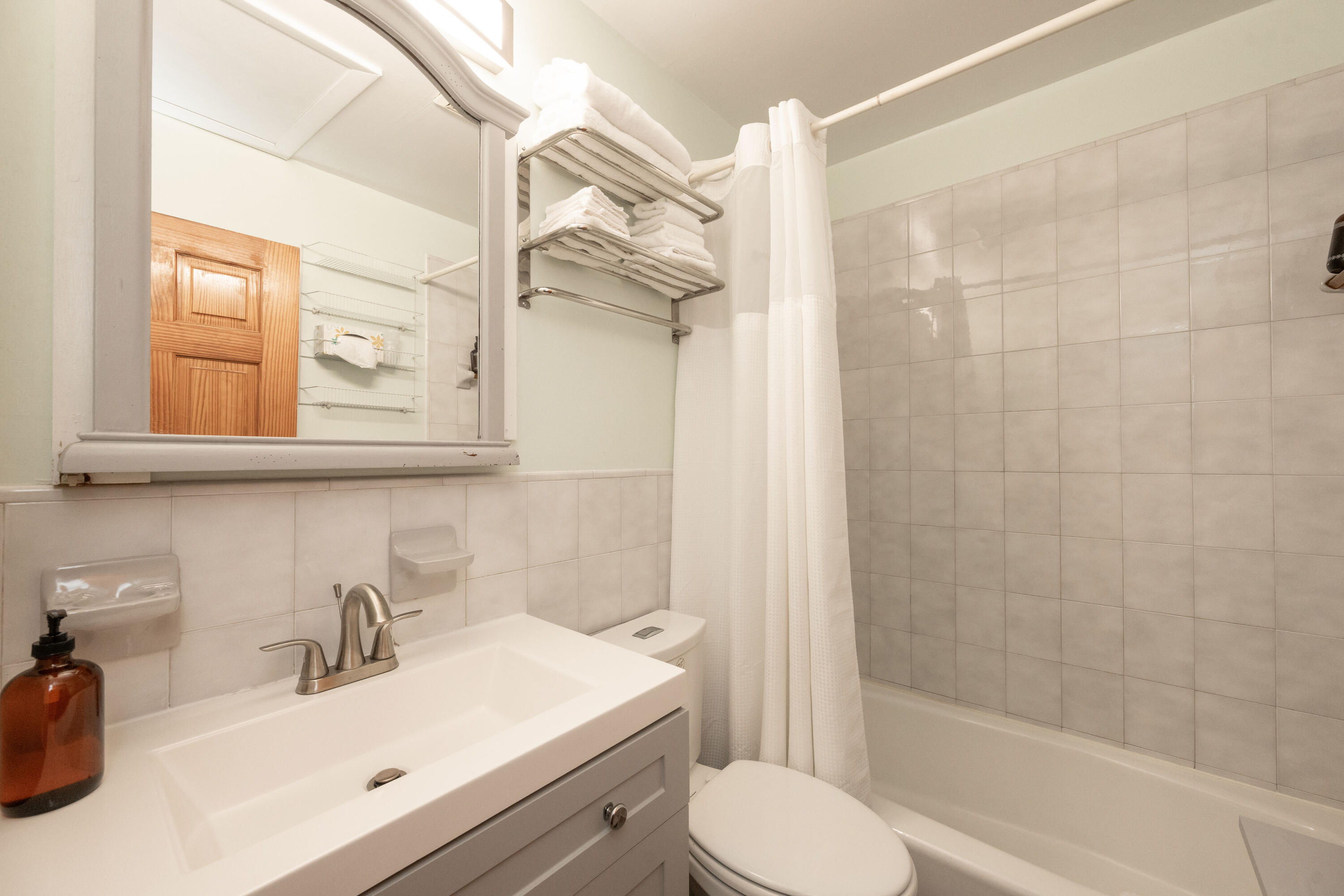 906 Truman Avenue, Unit 2 Key West, FL 33040 - Photo 23 of 33 a bathroom with a sink toilet a mirror and shower