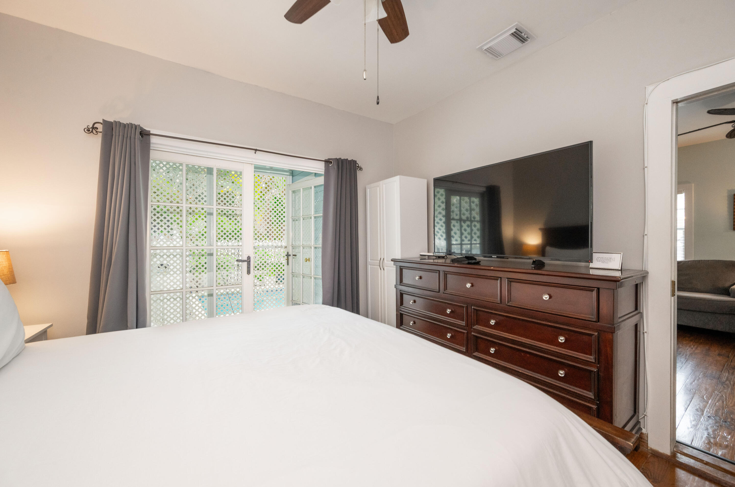 906 Truman Avenue, Unit 2 Key West, FL 33040 - Photo 28 of 33 a bedroom with a bed and a flat screen tv