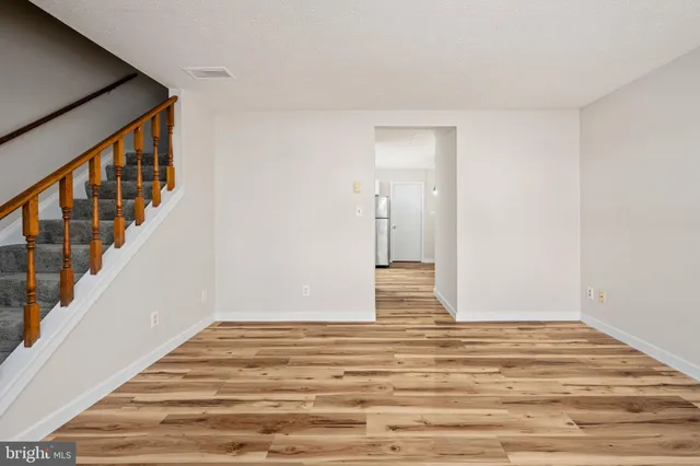 a kitchen with stainless steel appliances granite countertop a refrigerator sink and white cabinets