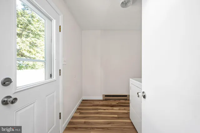 a view of a hallway with wooden floor