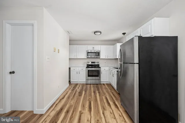 a view of a room with wooden floor and window