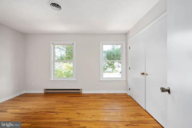 a view of room with wooden floor