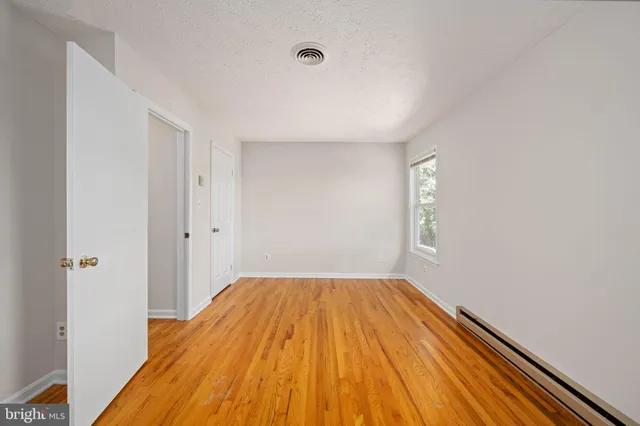a view of a refrigerator in kitchen and wooden floor