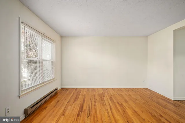 a view of a room with wooden floor and window
